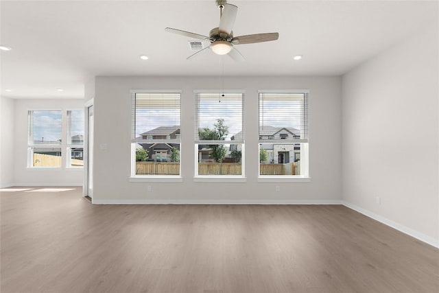 2705 Sage Ranch Dr Unit 22, Leander, TX 78641 - spare room featuring wood finished floors, plenty of natural light, a ceiling fan, and recessed lighting