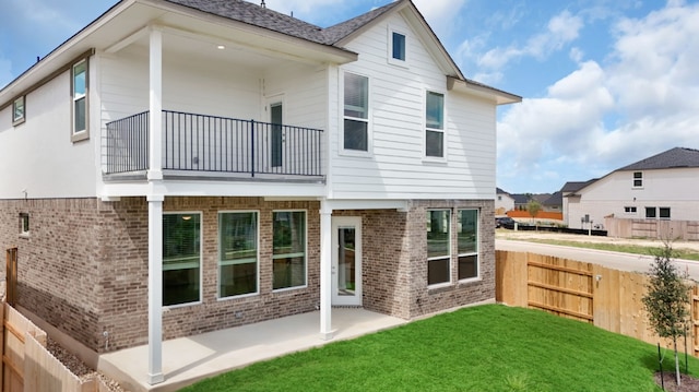 2705 Sage Ranch Dr Unit 22, Leander, TX 78641 - back of house featuring a balcony, brick siding, and a patio