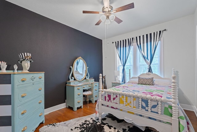 bedroom with baseboards, ceiling fan, and light wood finished floors