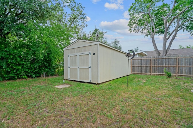 view of shed featuring fence
