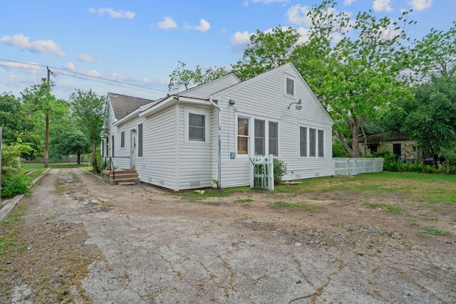 rear view of property with fence