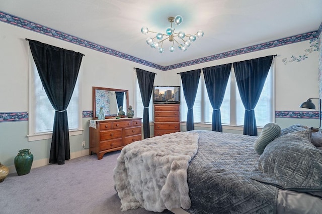 carpeted bedroom featuring an inviting chandelier and baseboards