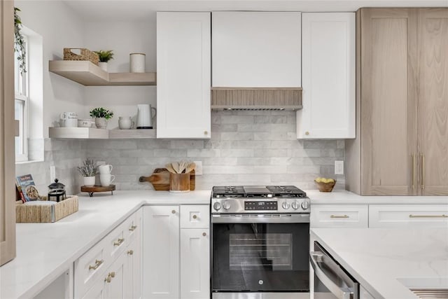 kitchen with white cabinets, stainless steel appliances, open shelves, and decorative backsplash