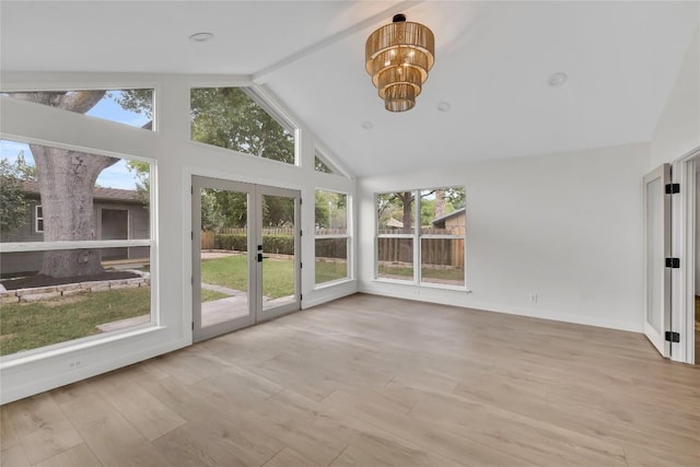 unfurnished sunroom featuring french doors, a notable chandelier, and a wealth of natural light