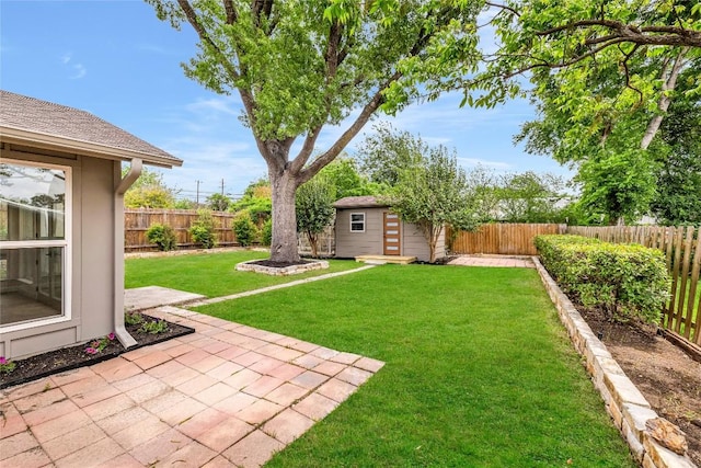 view of yard featuring an outdoor structure, a fenced backyard, and a patio area