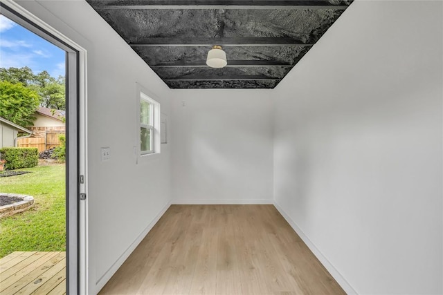 unfurnished room featuring baseboards and light wood-style flooring
