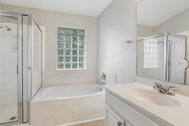 bathroom with vanity, a shower stall, and a garden tub