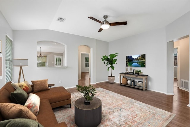 living room featuring visible vents, arched walkways, ceiling fan, and wood finished floors