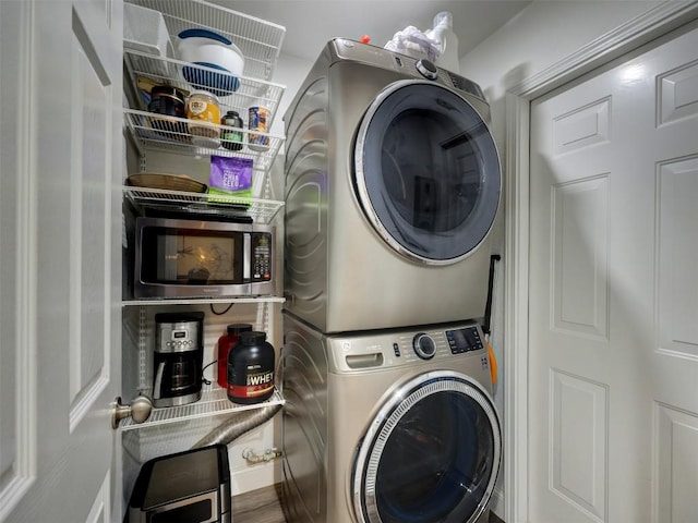 laundry area with stacked washing machine and dryer