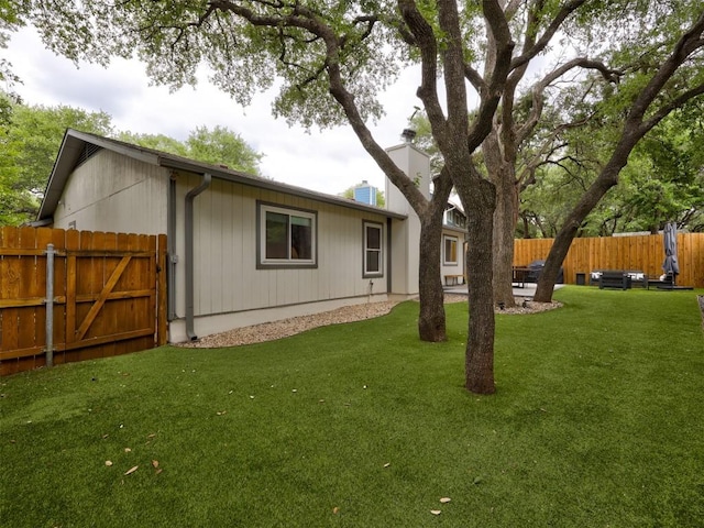 rear view of property with a gate and a chimney