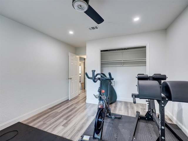 exercise room with a ceiling fan, wood finished floors, baseboards, and recessed lighting