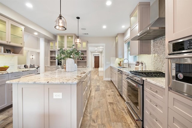 5517 Woodview Ave, Austin, TX 78756 - kitchen with open shelves, a sink, wall chimney exhaust hood, a center island, and stainless steel appliances