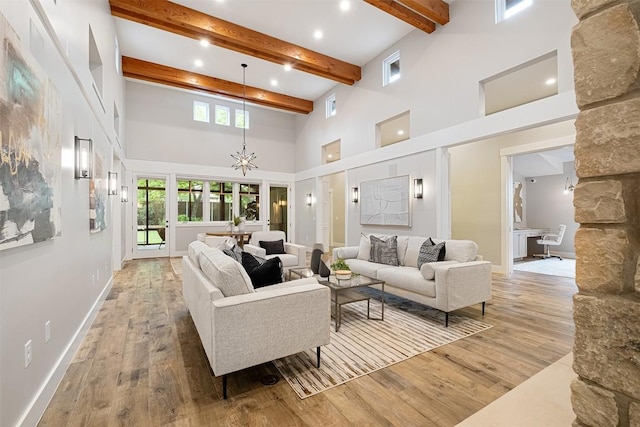 5517 Woodview Ave, Austin, TX 78756 - living room featuring a towering ceiling, a chandelier, hardwood / wood-style floors, and beamed ceiling