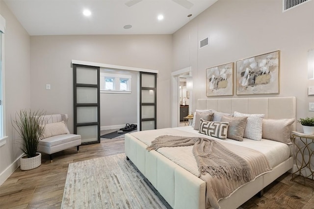 5517 Woodview Ave, Austin, TX 78756 - bedroom featuring baseboards, visible vents, wood finished floors, and high vaulted ceiling
