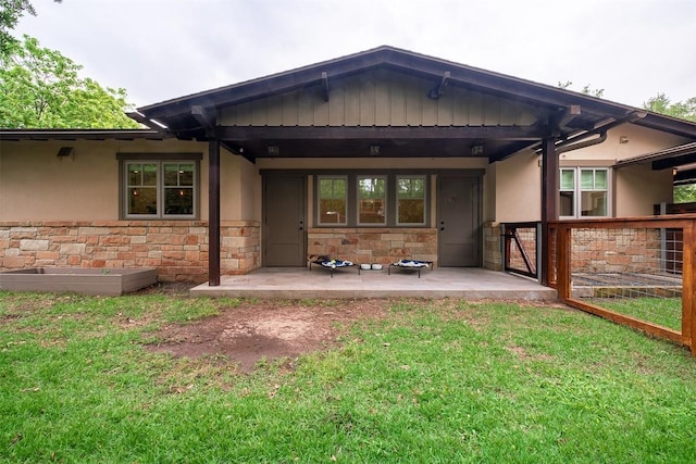 5517 Woodview Ave, Austin, TX 78756 - rear view of house featuring stucco siding, a yard, and stone siding