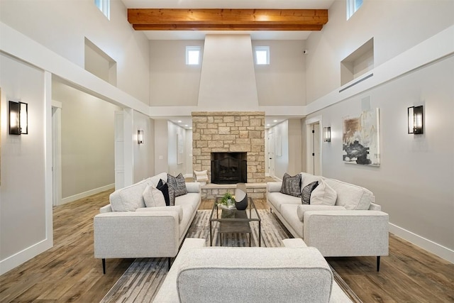 5517 Woodview Ave, Austin, TX 78756 - living room featuring baseboards, beam ceiling, wood finished floors, and a towering ceiling