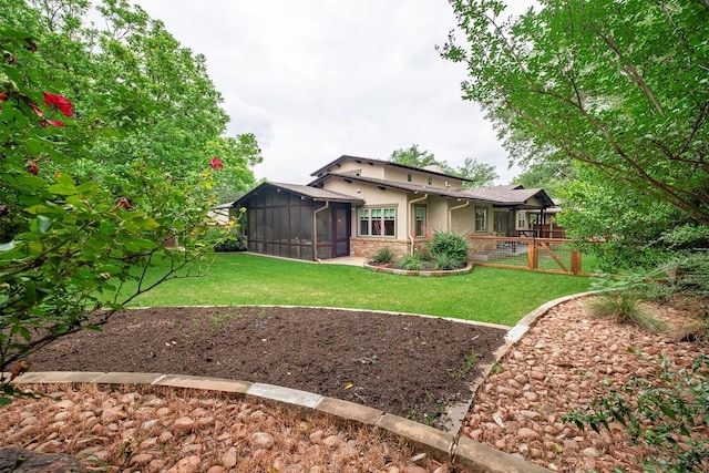 5517 Woodview Ave, Austin, TX 78756 - rear view of house featuring a lawn, a sunroom, fence, stone siding, and stucco siding