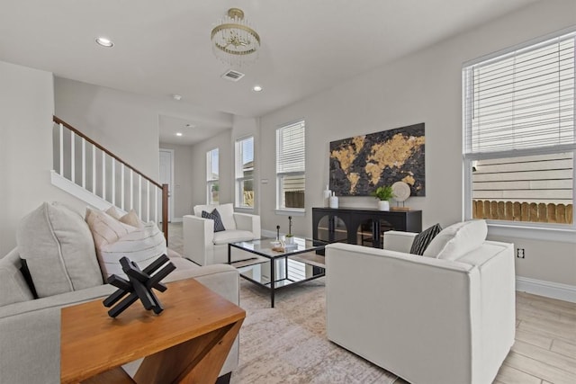 living room featuring stairway, baseboards, recessed lighting, and visible vents