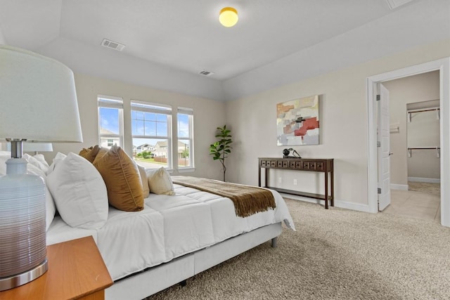 carpeted bedroom featuring visible vents and baseboards