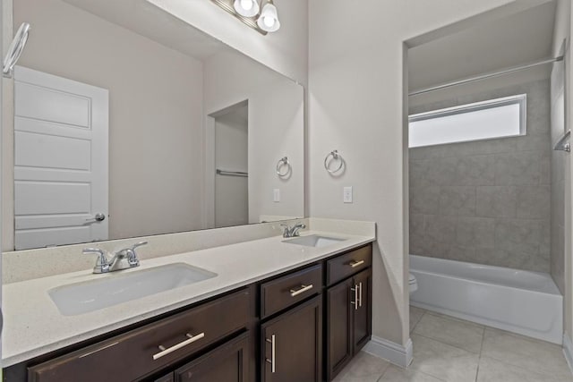bathroom with a sink, tile patterned flooring, toilet, and double vanity