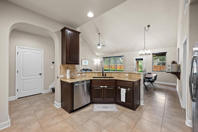 kitchen featuring dark brown cabinets, a sink, dishwasher, a peninsula, and decorative backsplash