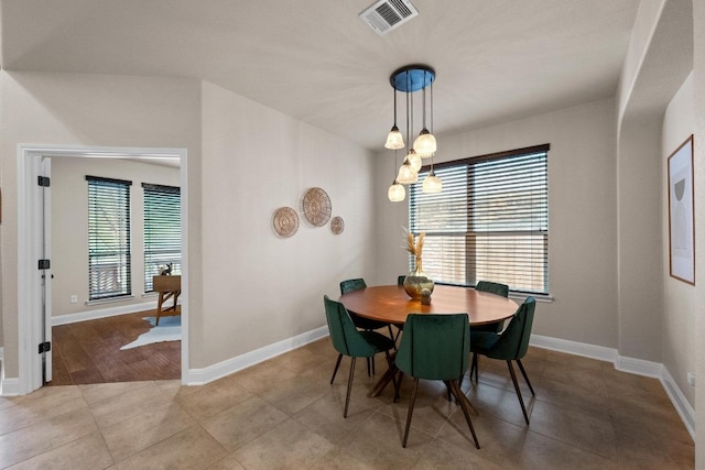 dining area featuring tile patterned floors, visible vents, and baseboards