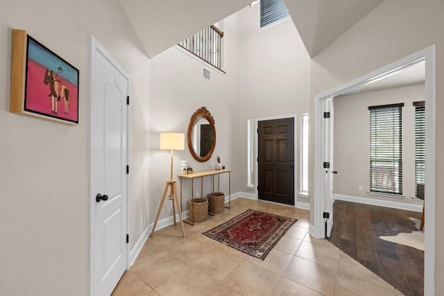 entryway with tile patterned floors, visible vents, and baseboards