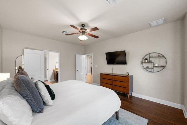 bedroom with baseboards, visible vents, and wood finished floors