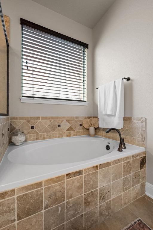 bathroom with a bath and a wealth of natural light