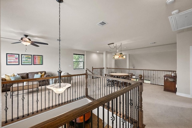 hallway with visible vents, attic access, and carpet