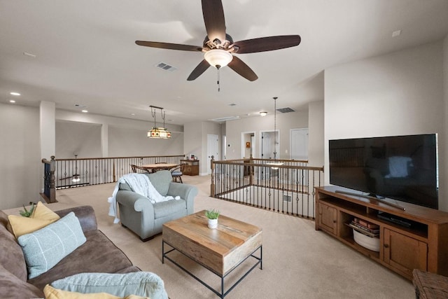 living room featuring a ceiling fan, recessed lighting, light colored carpet, and visible vents