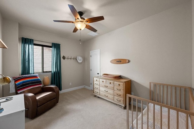 bedroom featuring light colored carpet, a ceiling fan, and baseboards