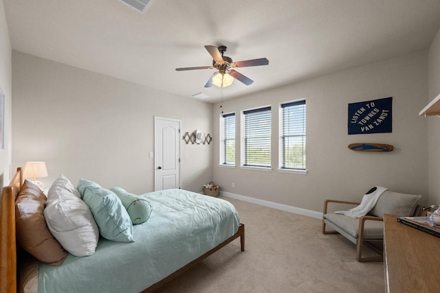 bedroom featuring baseboards, visible vents, light carpet, and ceiling fan