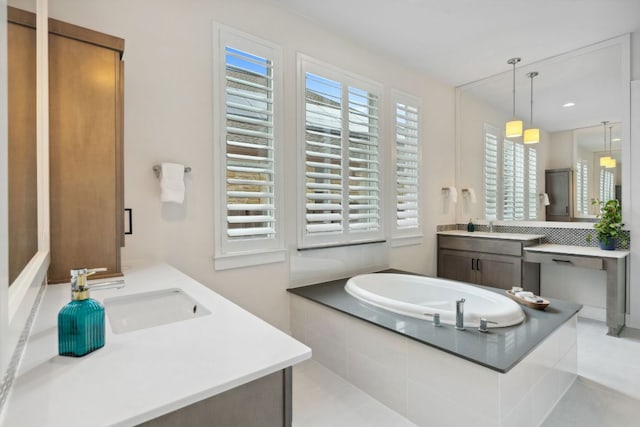 bathroom featuring a shower stall, a garden tub, and vanity