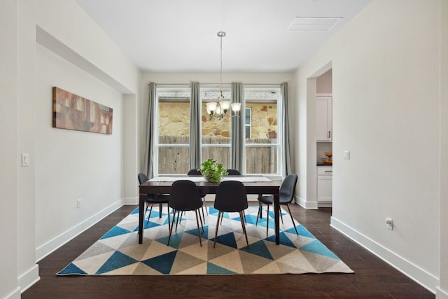 dining room with an inviting chandelier, baseboards, dark wood finished floors, and visible vents