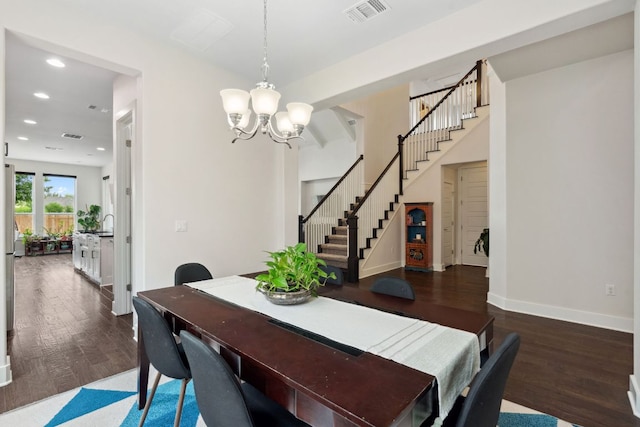 dining room with visible vents, stairs, wood finished floors, and a chandelier