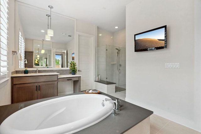 full bath featuring a bath, a shower stall, vanity, tile patterned floors, and baseboards