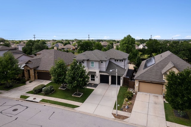 14108 Laurinburg Dr, Austin, TX 78717 - view of front of house with driveway, a residential view, stone siding, a front yard, and a garage