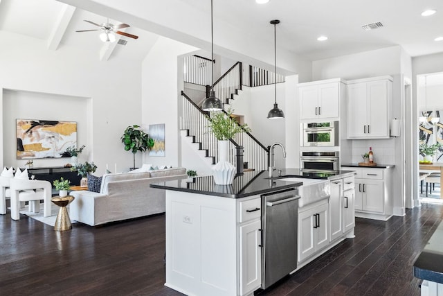 14108 Laurinburg Dr, Austin, TX 78717 - kitchen with stainless steel appliances, dark countertops, dark wood-style floors, high vaulted ceiling, and open floor plan