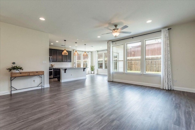 3209 Maysillee St, Austin, TX 78728 - unfurnished living room with recessed lighting, baseboards, a ceiling fan, and dark wood-style flooring