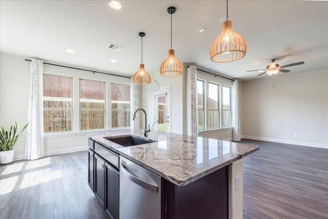 kitchen featuring baseboards, visible vents, a sink, and dishwasher