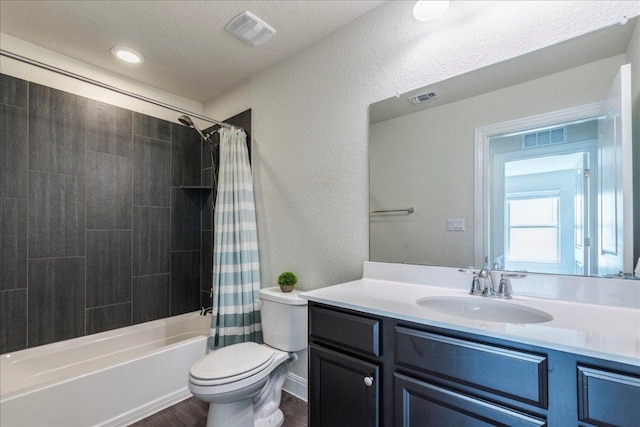 full bathroom featuring visible vents, toilet, and vanity