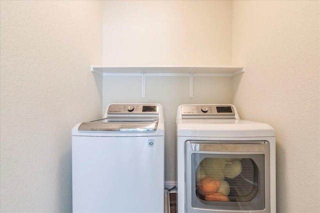laundry area with laundry area and washer and clothes dryer