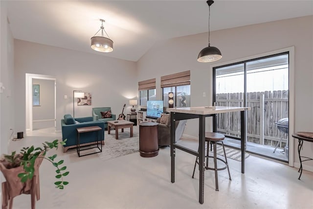 dining space with concrete flooring and lofted ceiling