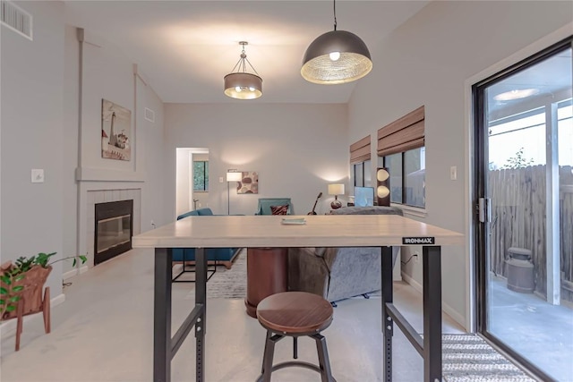 dining room featuring baseboards, visible vents, and a fireplace