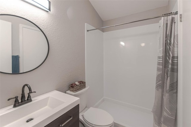 bathroom featuring vanity, a shower with curtain, and toilet