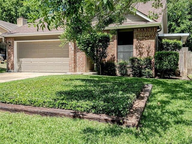 618 Smoke Signal Pass, Pflugerville, TX 78660 - view of property hidden behind natural elements with brick siding, an attached garage, a front yard, and driveway