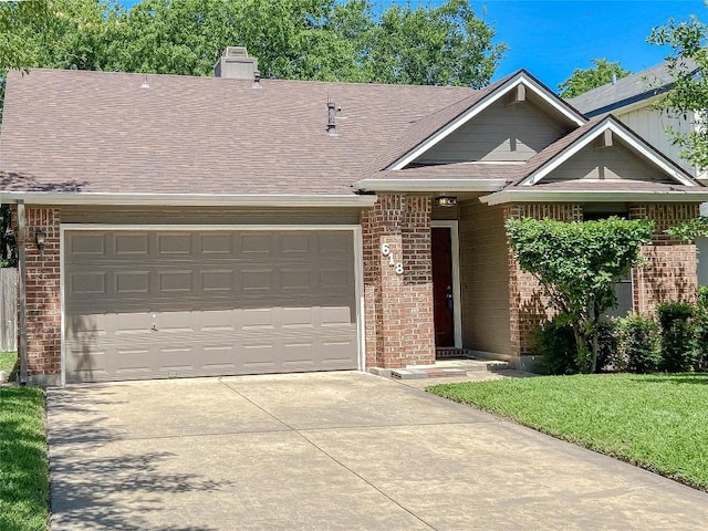 618 Smoke Signal Pass, Pflugerville, TX 78660 - view of front of house with brick siding, driveway, and roof with shingles