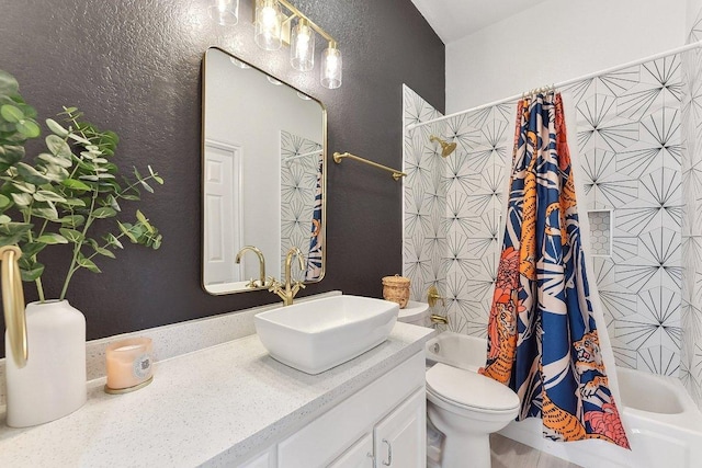 full bathroom featuring vanity, a textured wall, shower / bath combo with shower curtain, and toilet