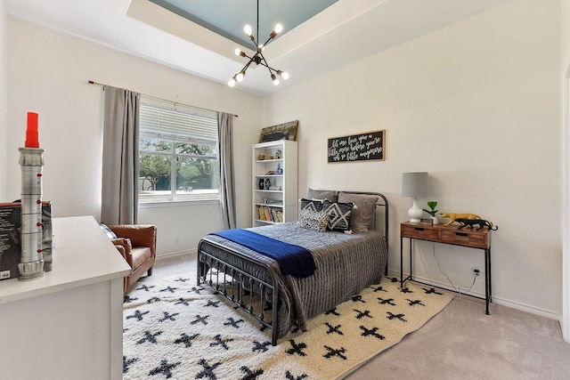 bedroom with baseboards, a notable chandelier, and light carpet